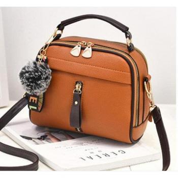 Bandolera de piel sintética con decoración de bola de pelo